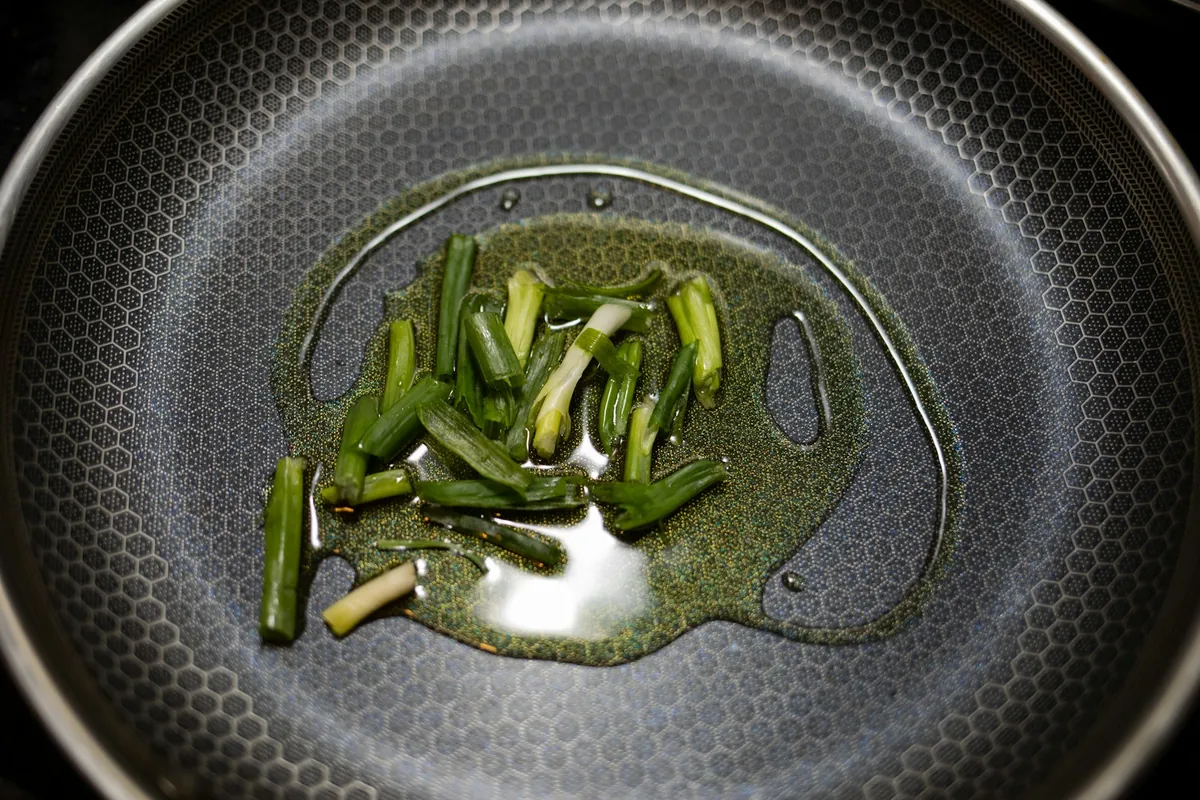 Shallots and aromatics frying slowly in oil