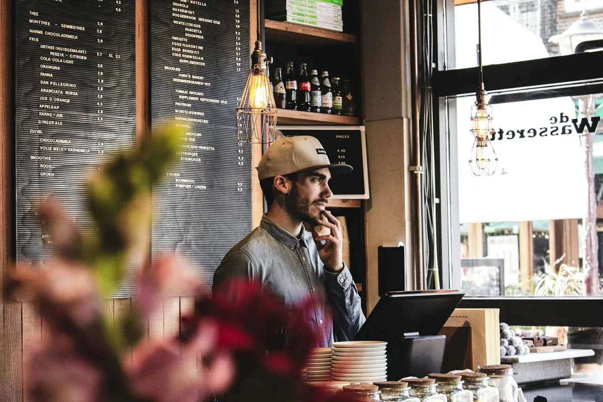 A customer asking a question at a restaurant counter