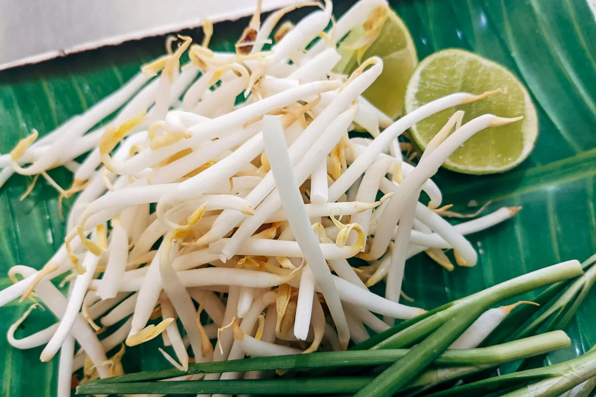 Bean sprouts and sliced vegetables cooking quickly over heat