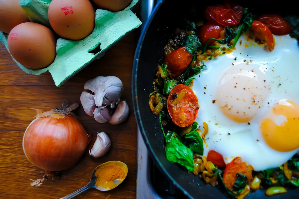 Beaten eggs ready for cooking with vegetables