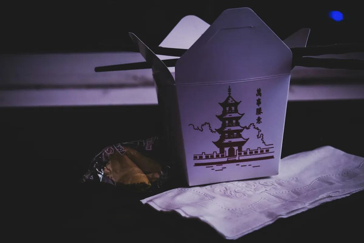 A sauced beef dish packed in a takeout container