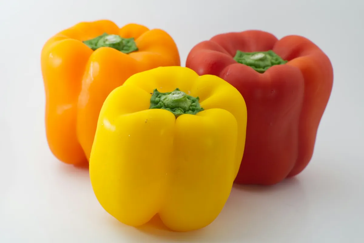 Green and red bell peppers cut into strips