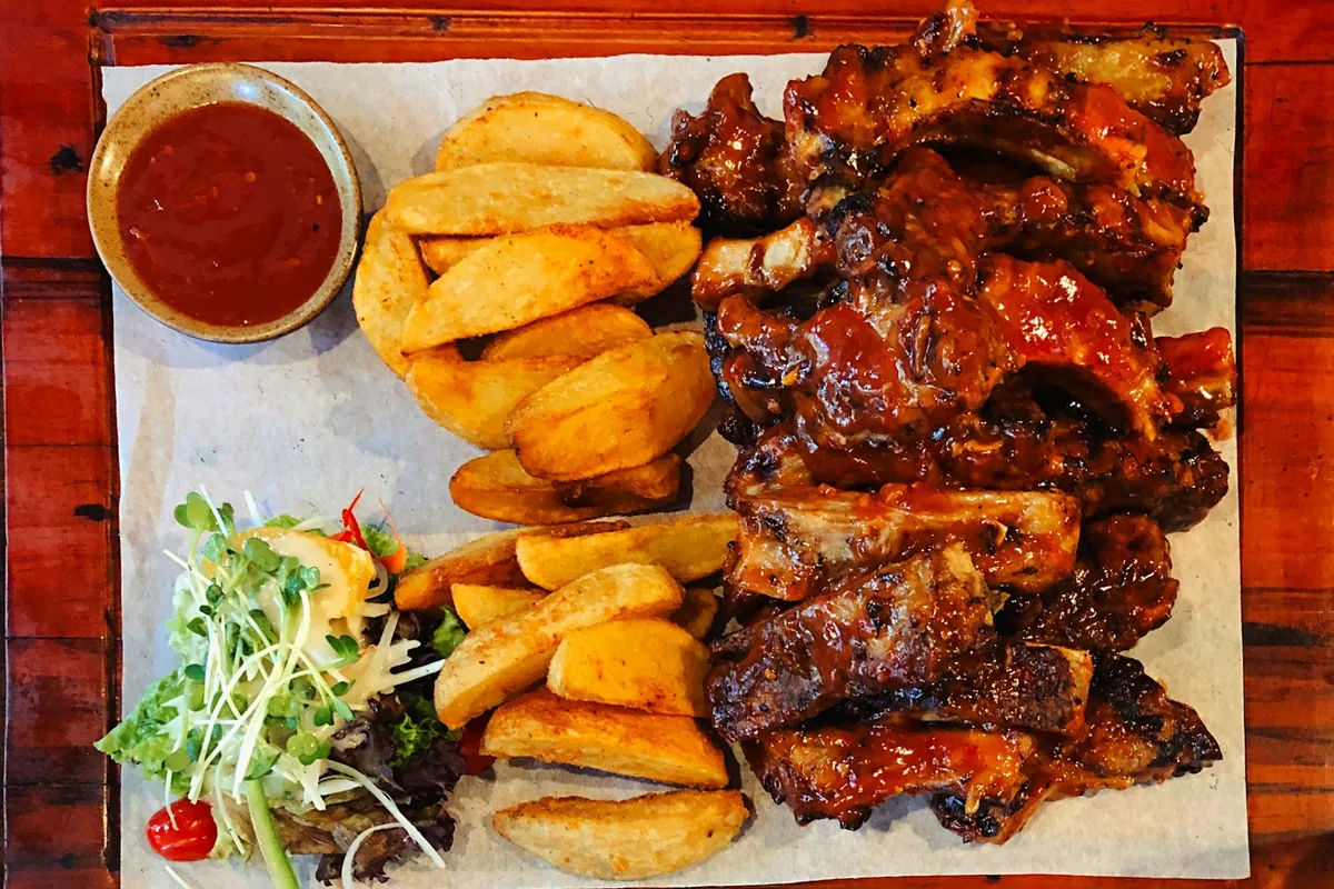 A green vegetable dish among richer Chinese dishes