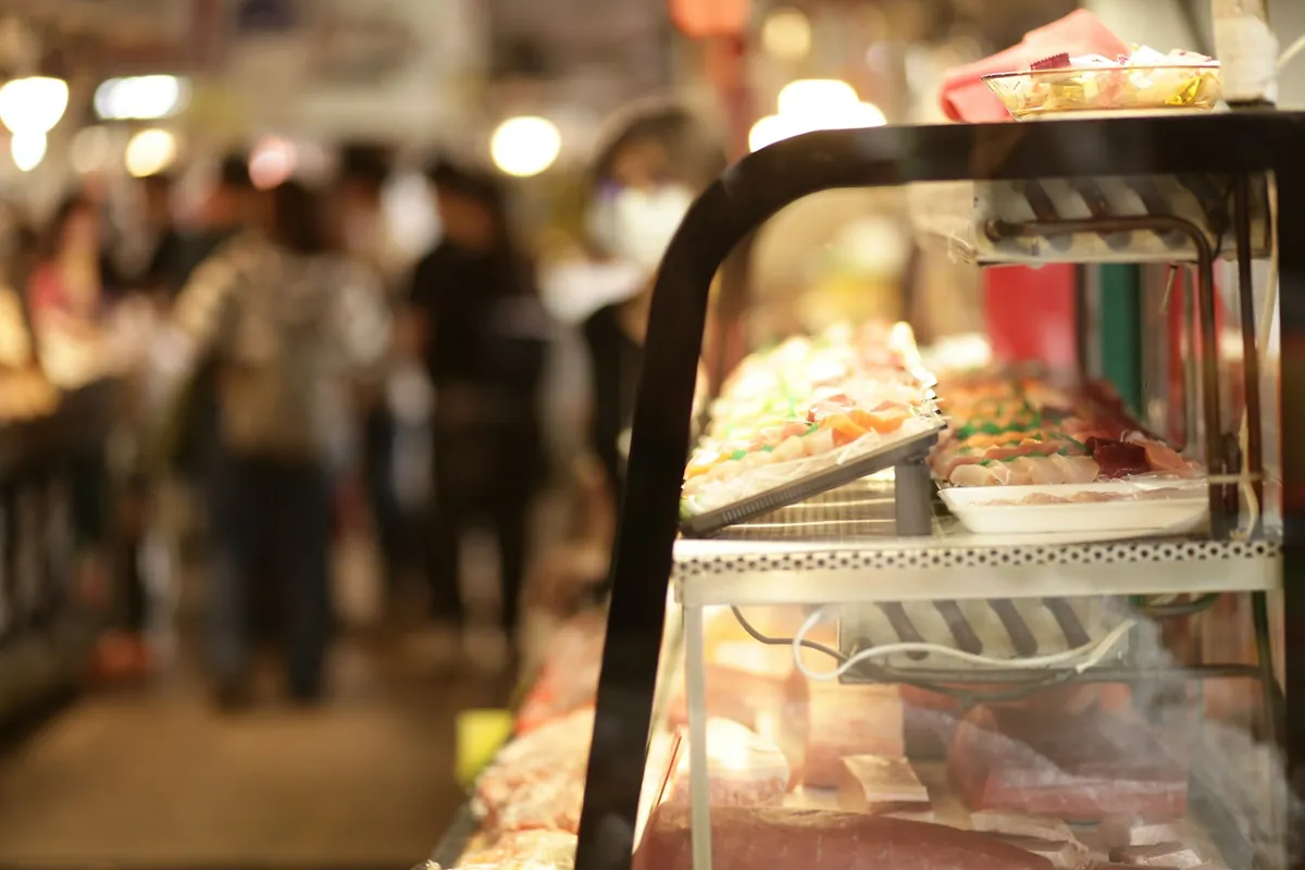 A busy takeout counter with customers waiting