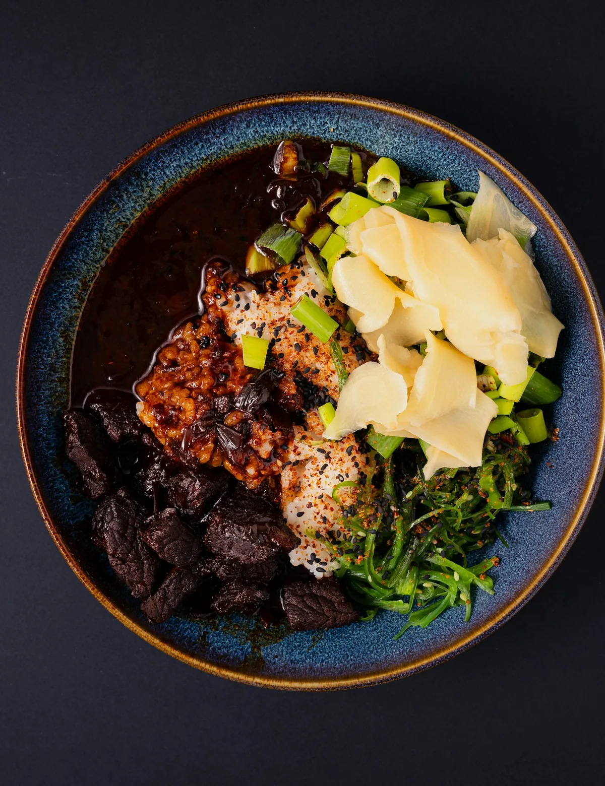 A bowl of Chinese food with meat and vegetables