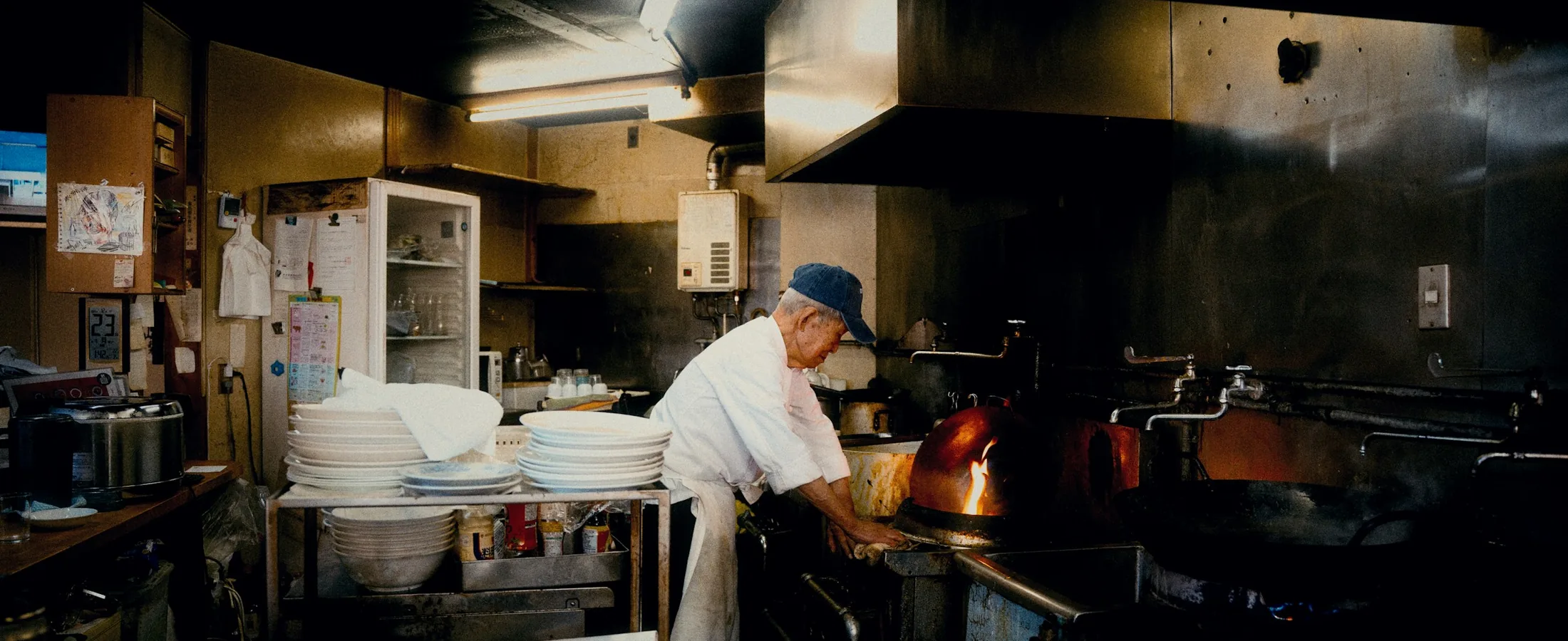 A chef at work in a busy restaurant kitchen