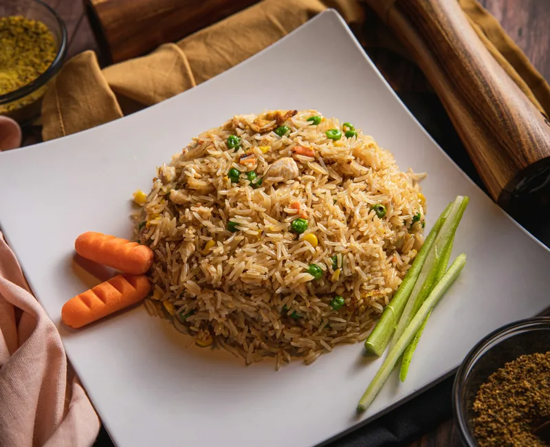 Chinese fried rice with peas, carrots and scallions