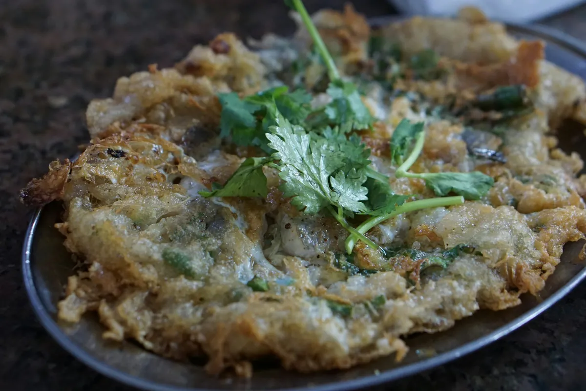 A plated Chinese-style omelette dish with sauce