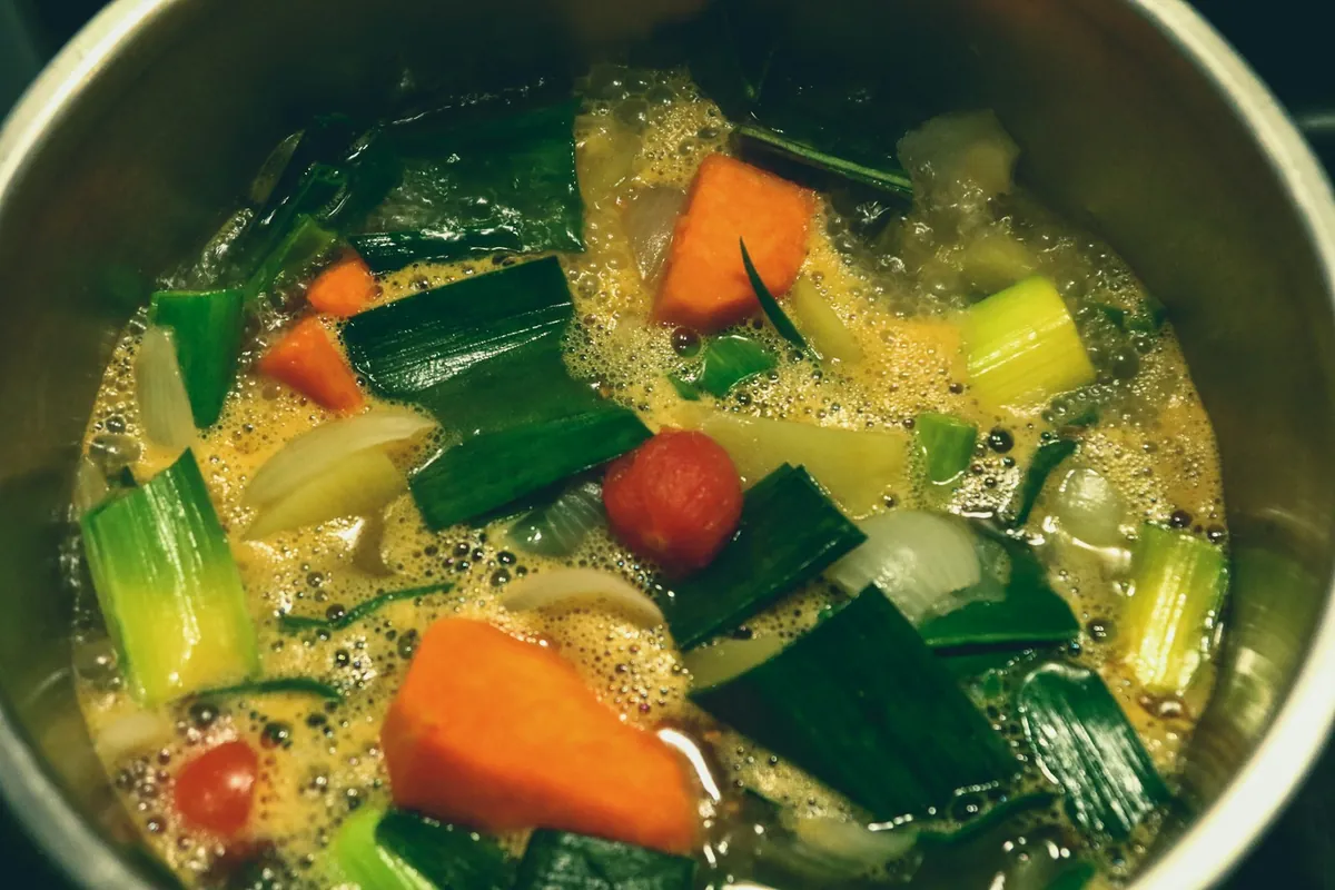 A bowl of Chinese soup with a clear broth