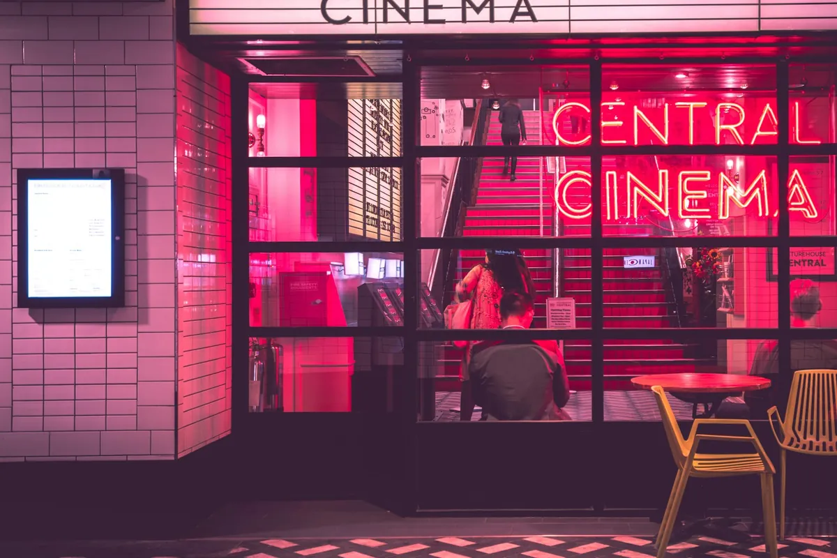 A cinema marquee lit at night