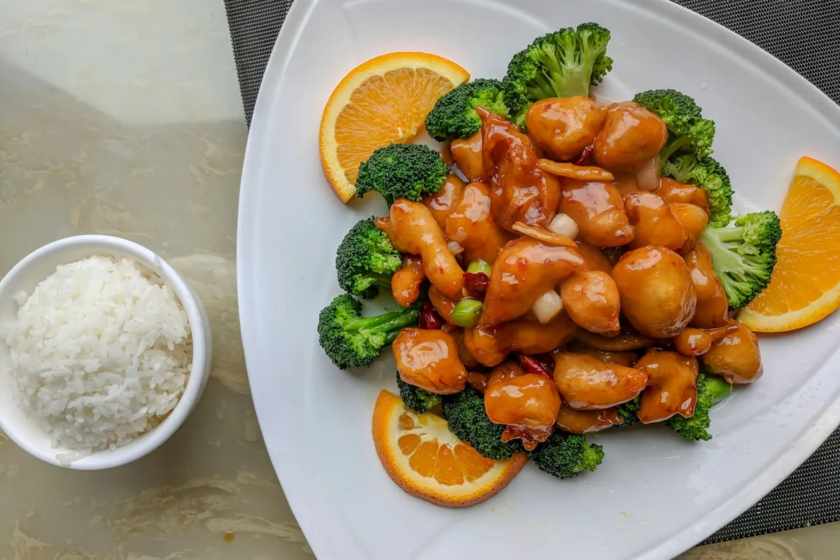 Chicken pieces in a bright orange-colored glaze