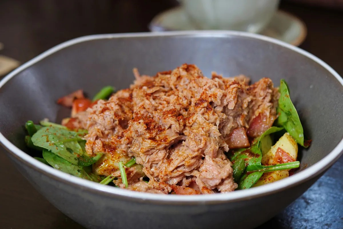 A close view of coconut chicken showing the coating and garnish