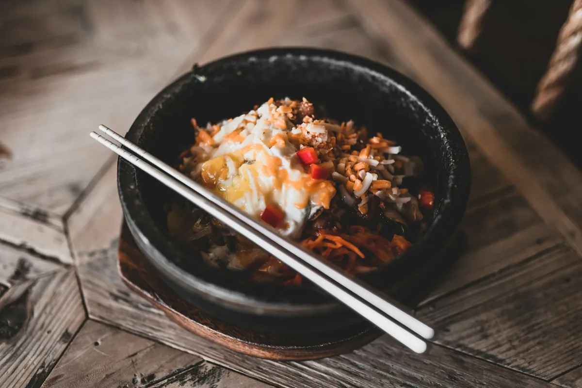 A single-portion plate of Chinese food served with rice