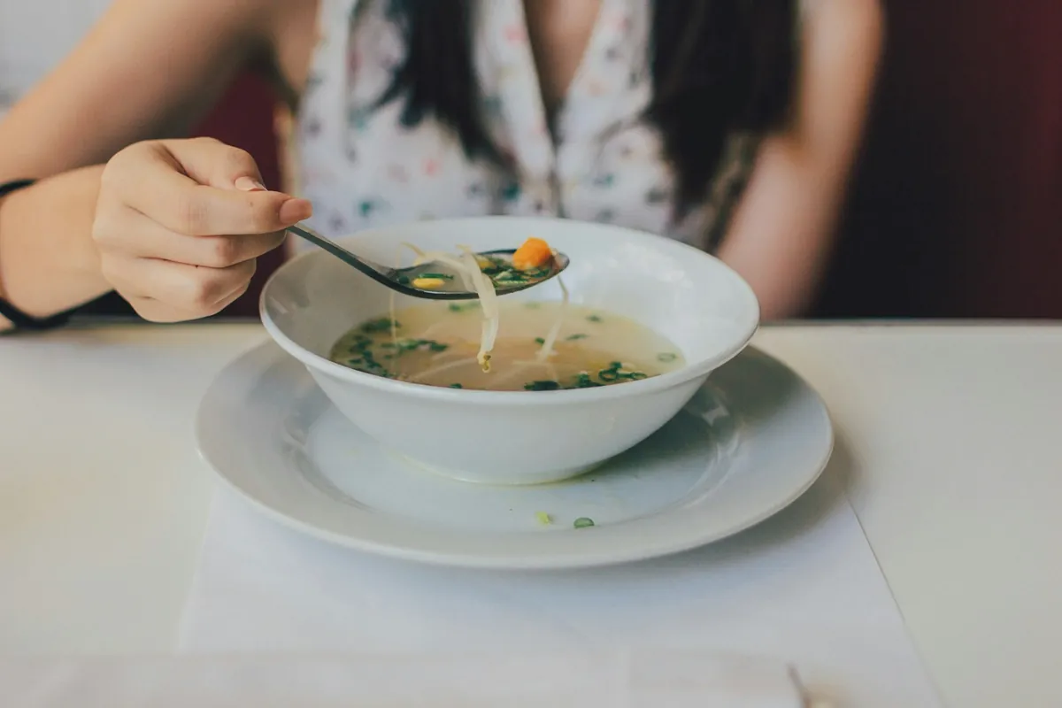 A bowl of porridge being eaten with a spoon