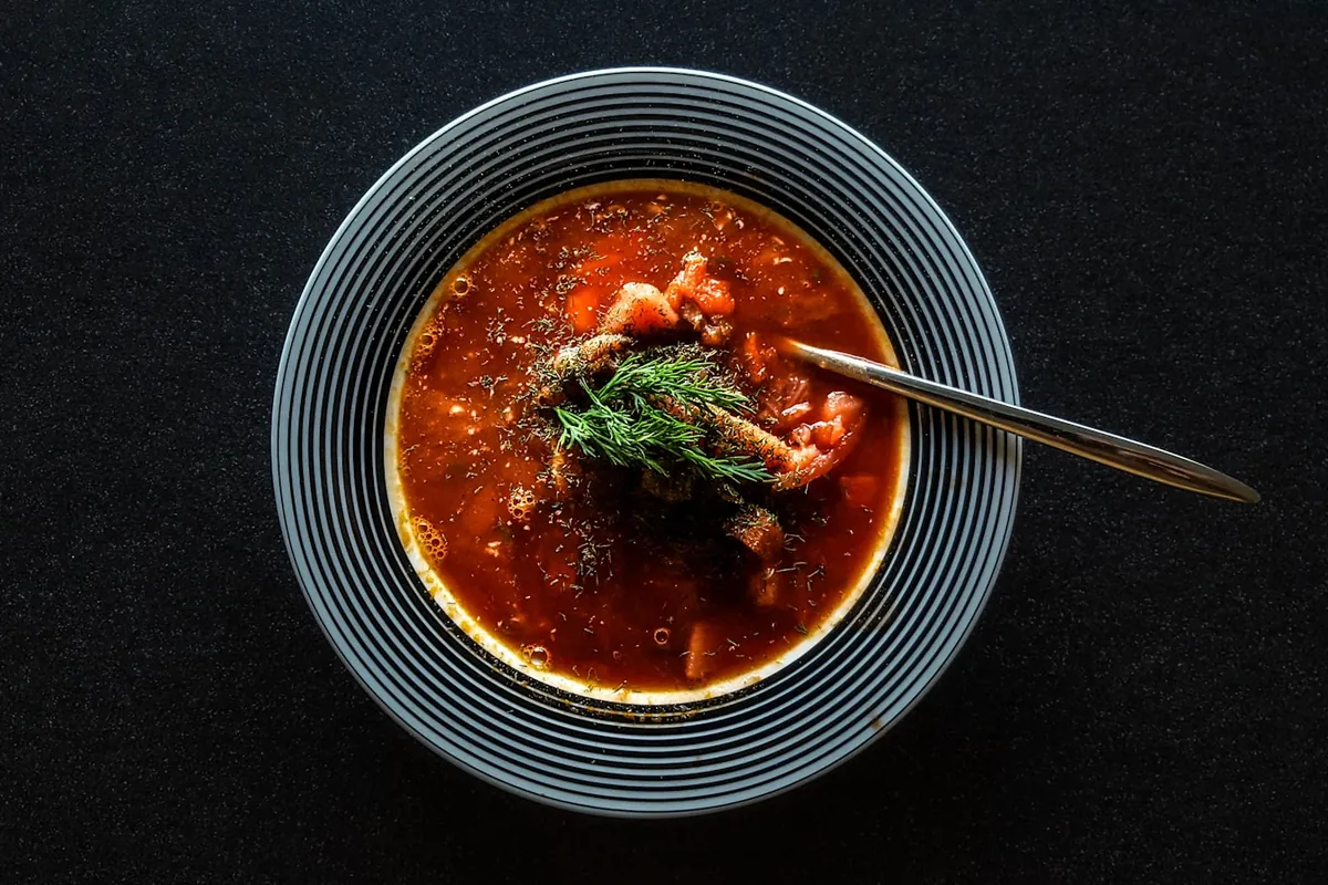 A darker, thicker soup with shredded vegetables