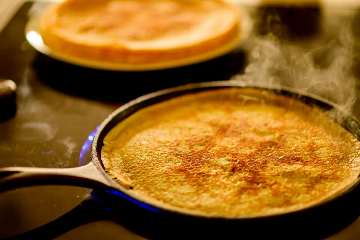 Steam rising as liquid hits a hot pan