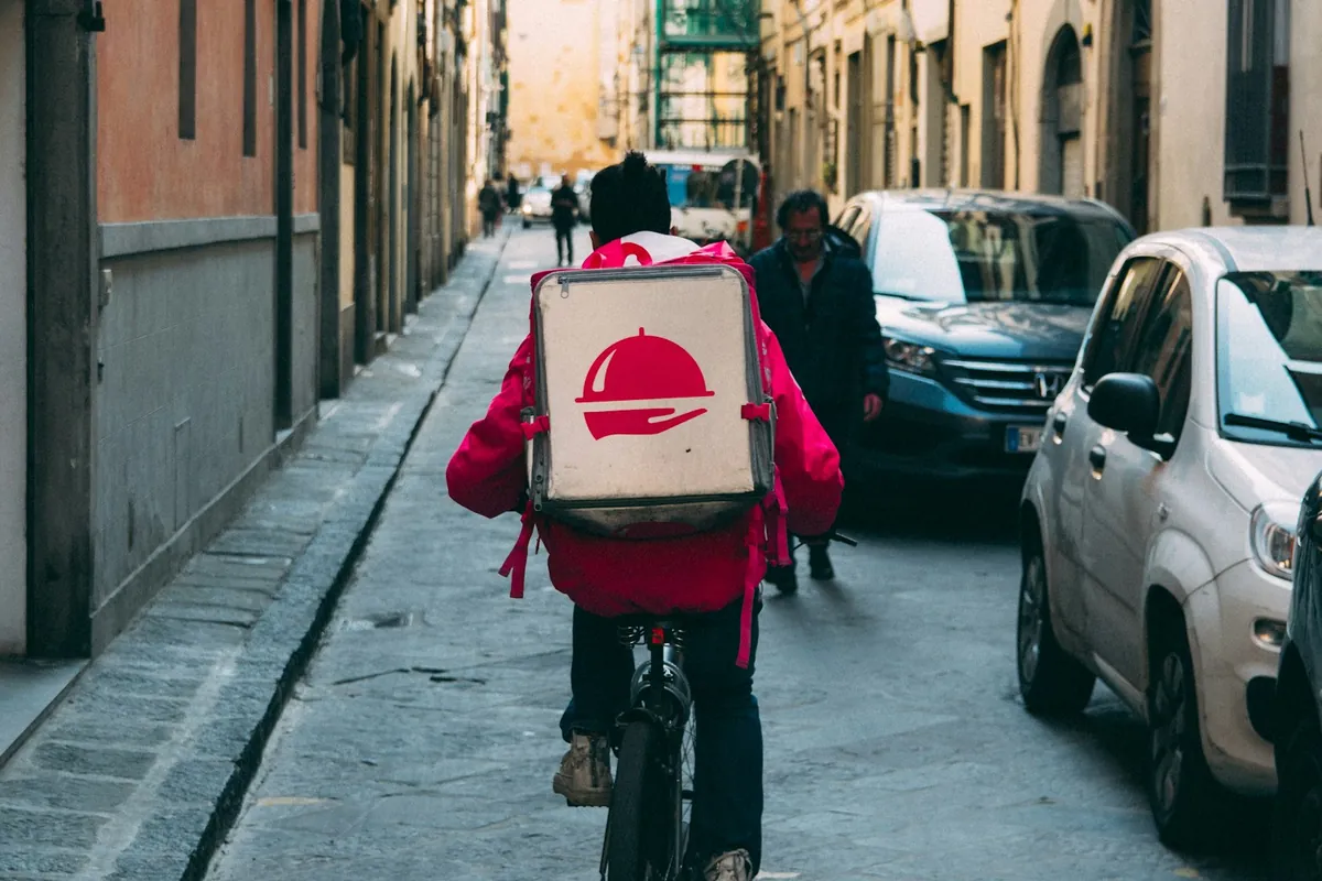 A delivery courier carrying an insulated bag
