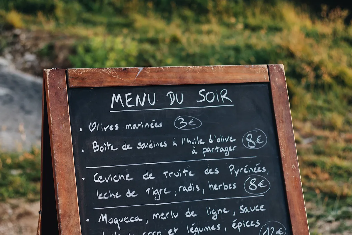 A menu board showing dish names