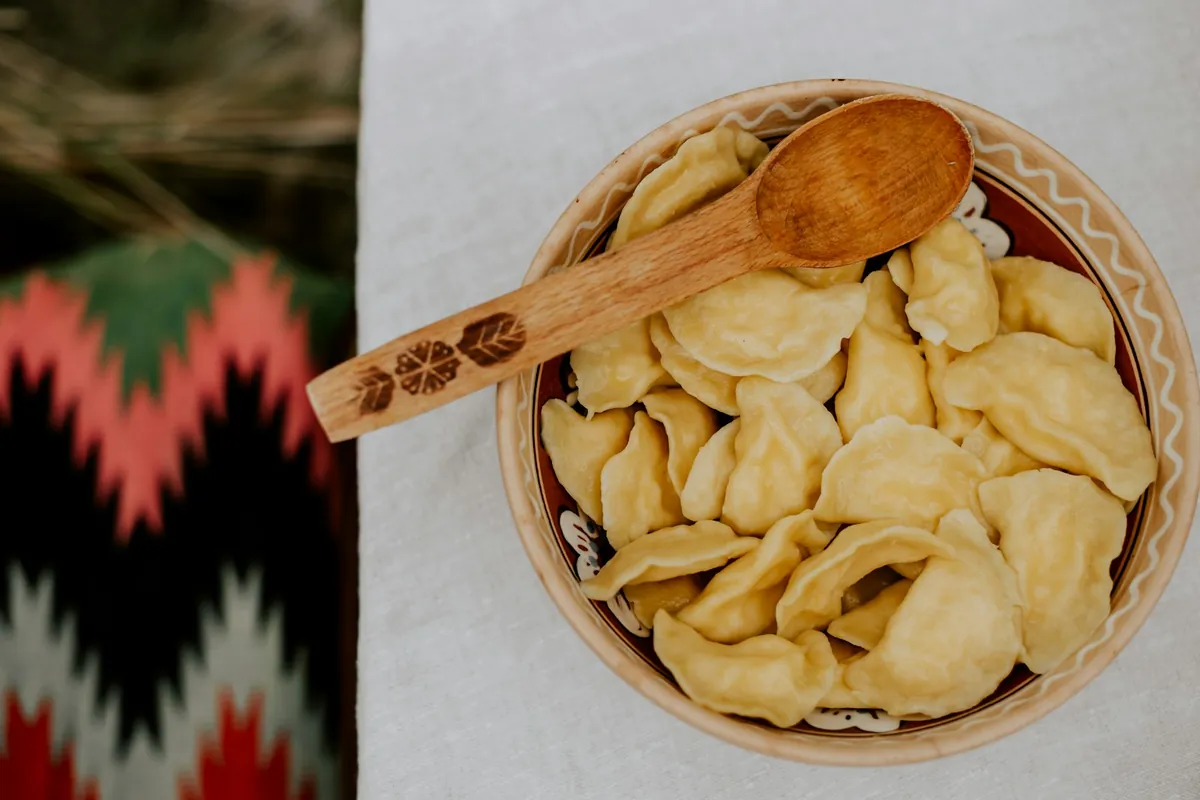 A soup dumpling resting on a spoon