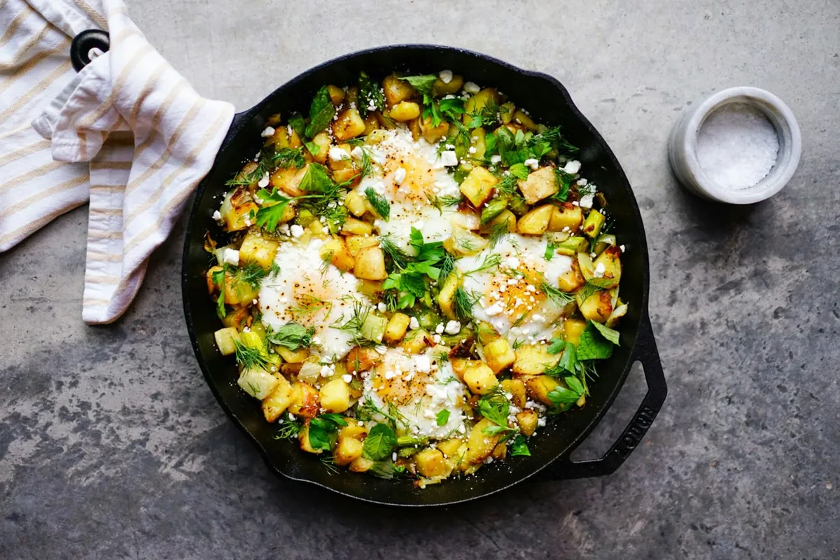 Beaten egg and vegetables cooking in a hot pan