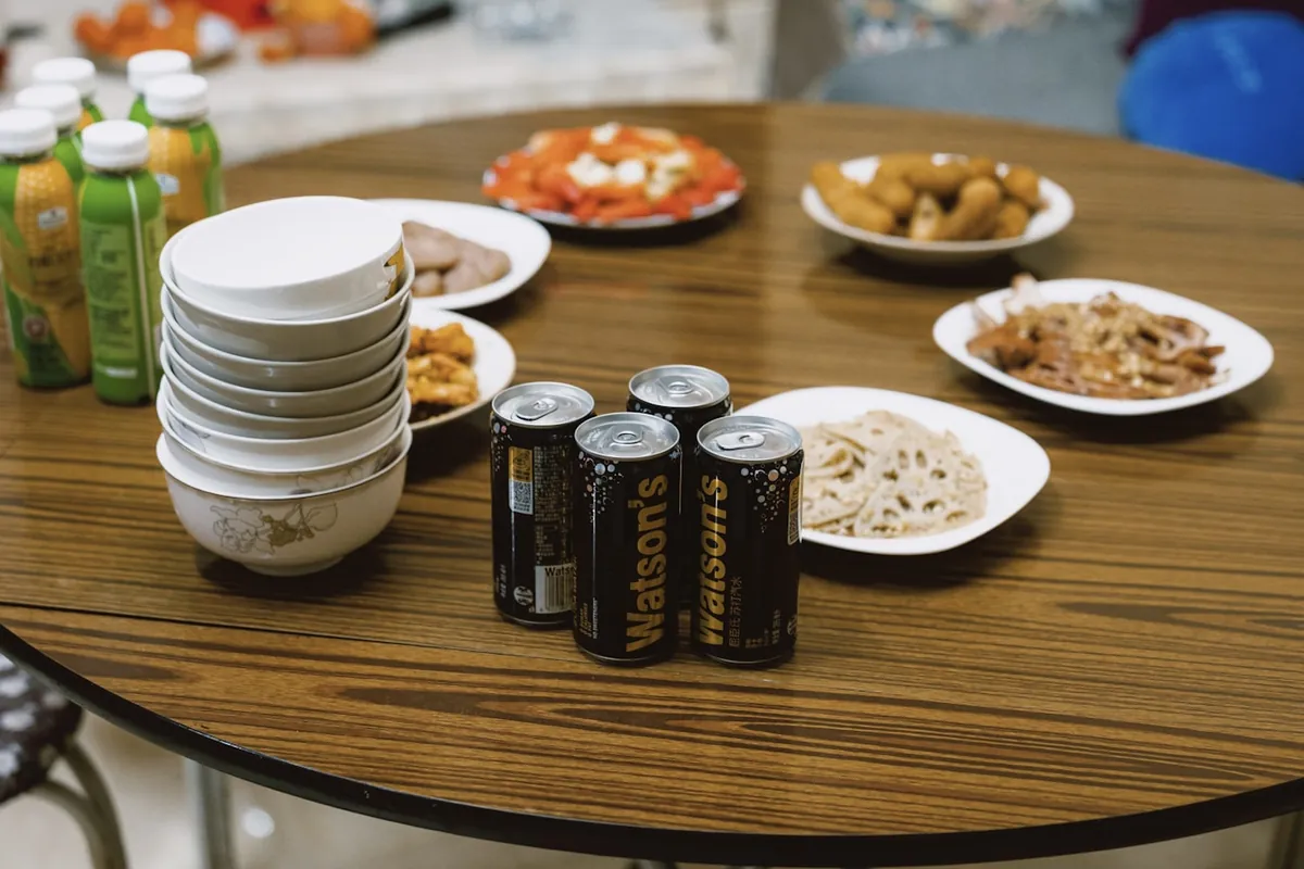 A group sharing several Chinese dishes at a table