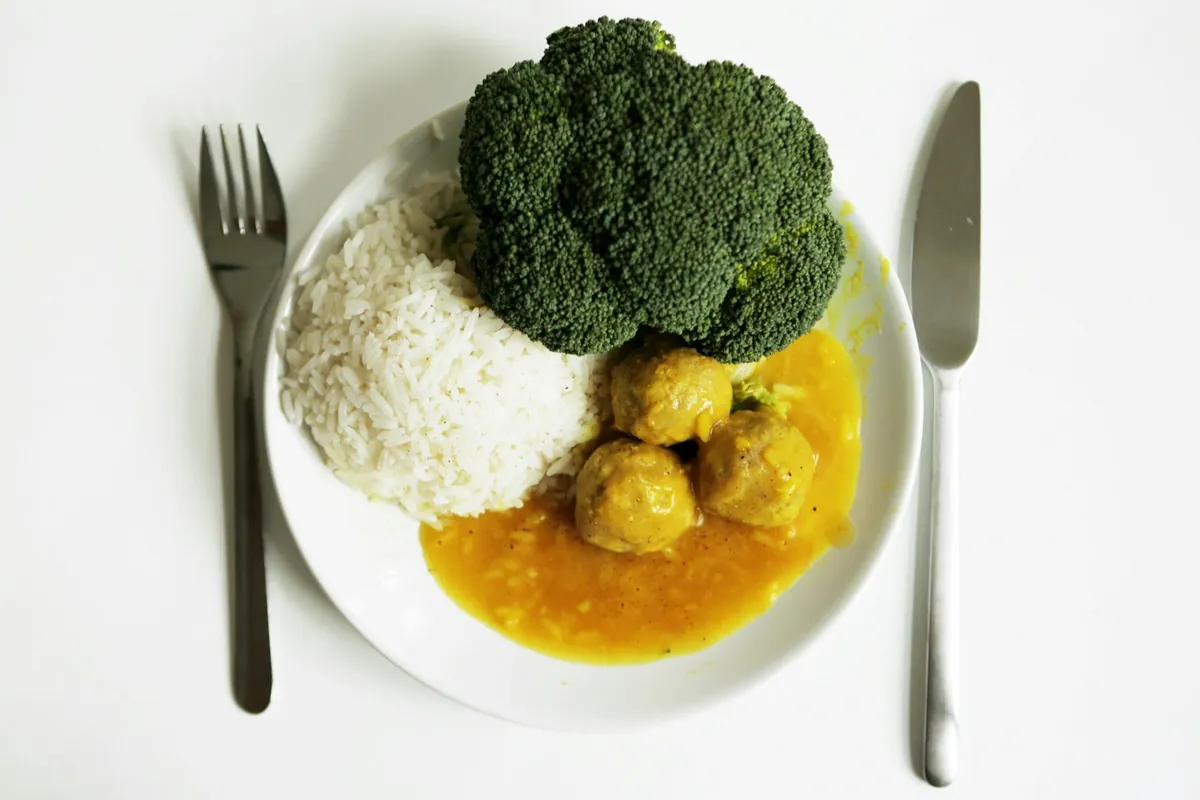 A fork being used to eat fried rice