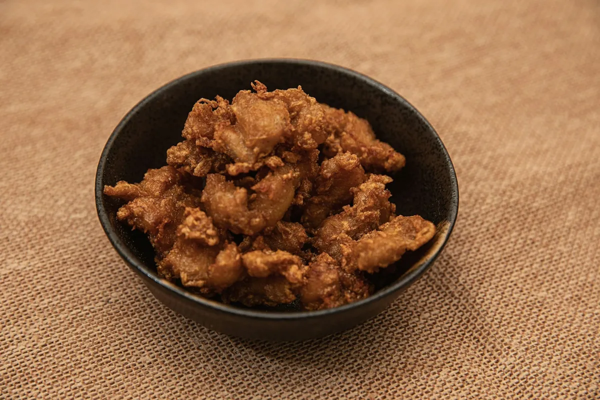 Small irregular fried pork pieces in a container