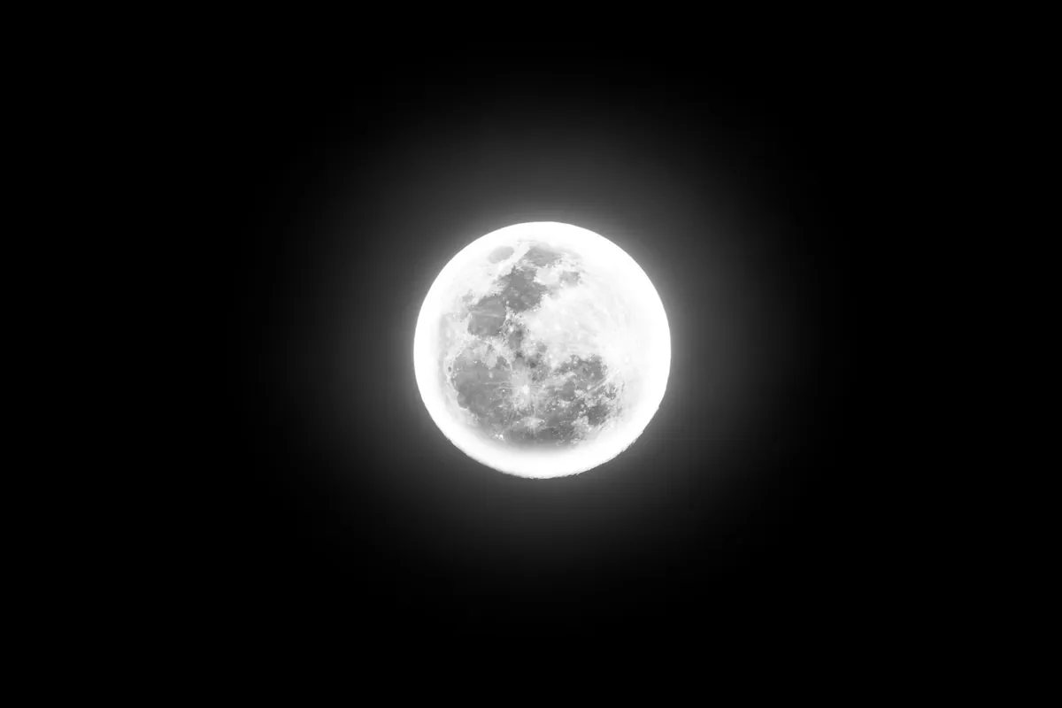 A full moon in an autumn night sky