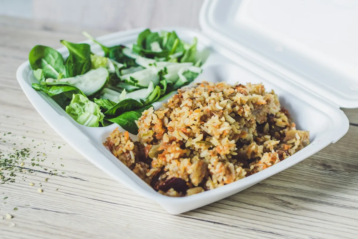 A takeout container with sauce packed separately