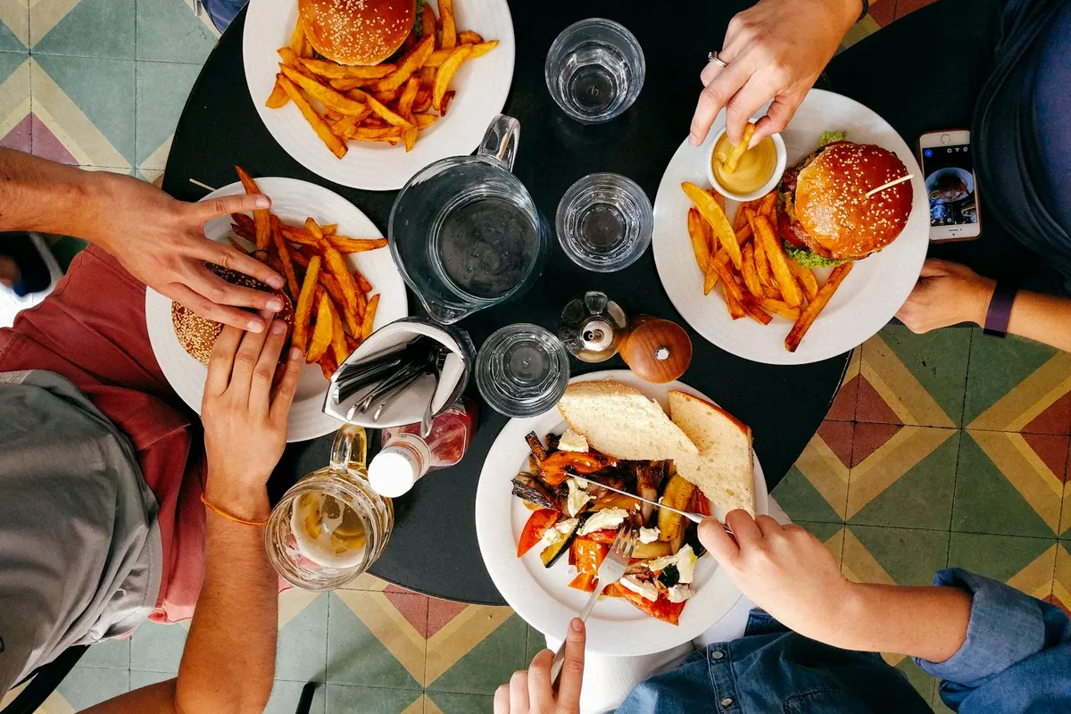 A group looking at something on a restaurant table