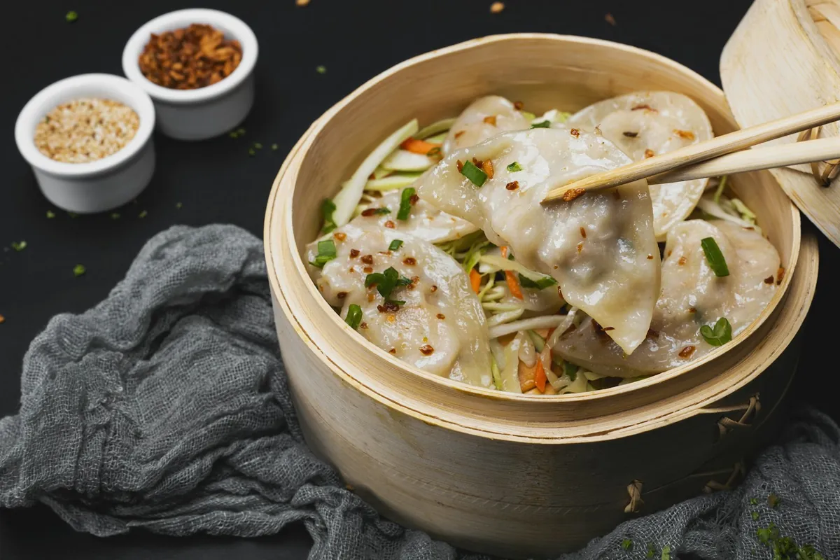 People serving themselves from shared Chinese dishes