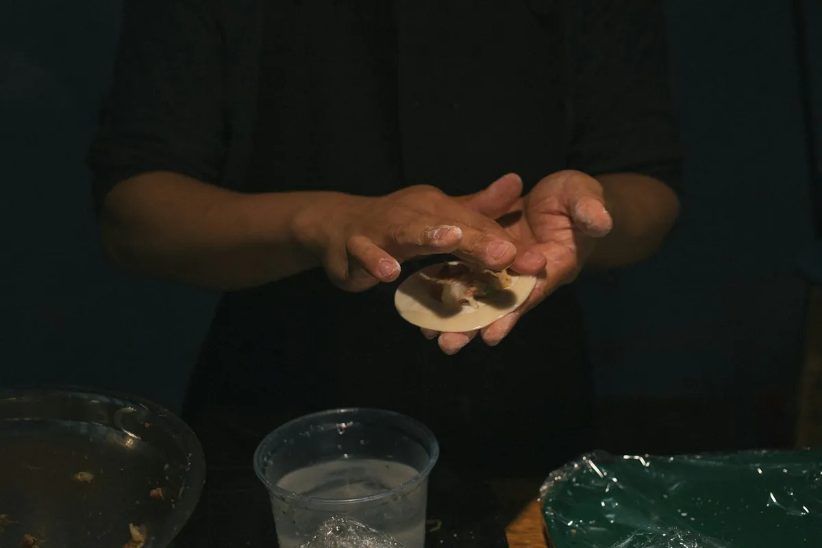 Dumplings being folded by hand