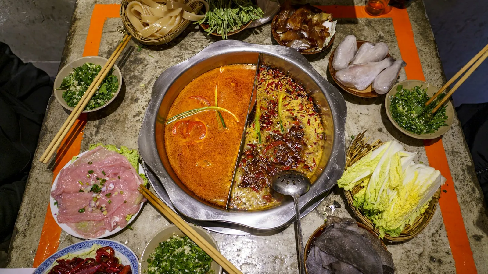 A hot pot simmering in the middle of a table