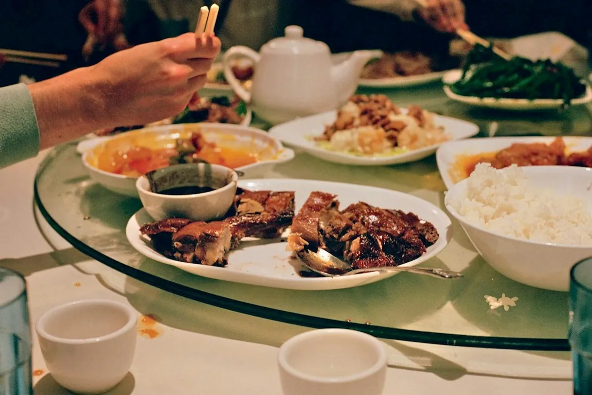 A plain steamed dish alongside richer Chinese dishes