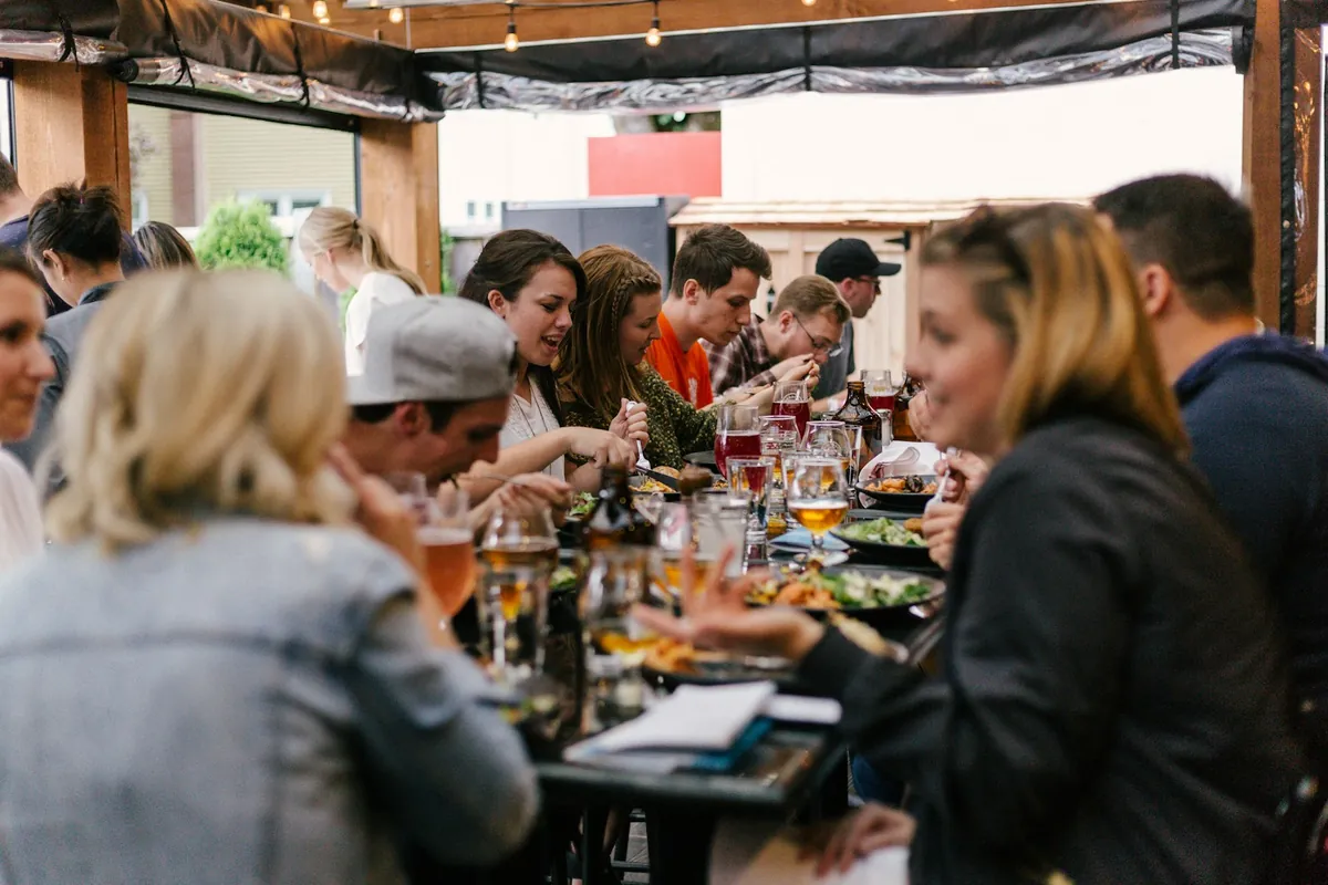 A group sharing a long daytime meal