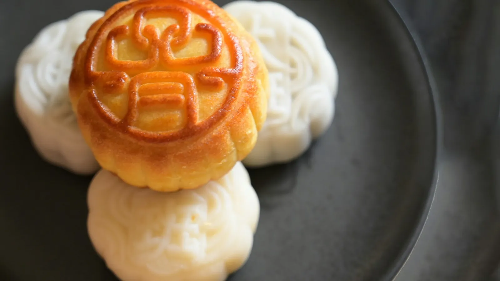 Round mooncakes arranged on a plate