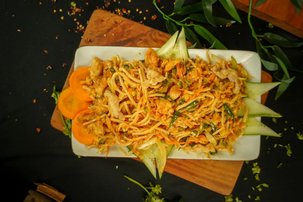 Stir-fried noodles mixed with vegetables and protein