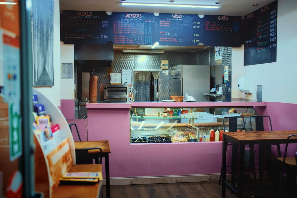 A customer placing an order at a restaurant counter
