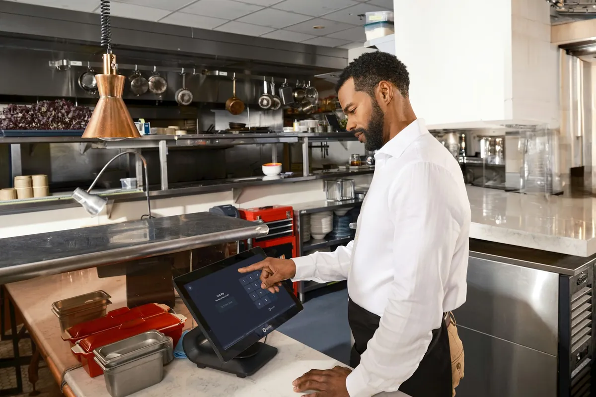 A customer ordering at a restaurant counter