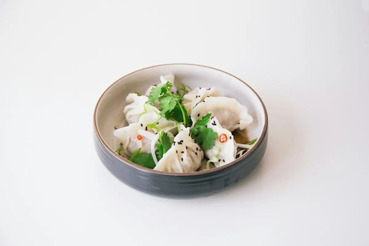 Plain steamed rice beside a dish of soy sauce