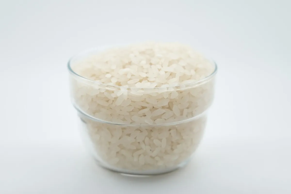 Plain steamed rice served beside a spicy dish