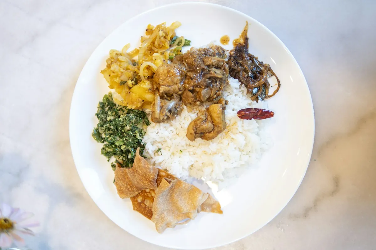 A mixed platter on a table with rice and other dishes