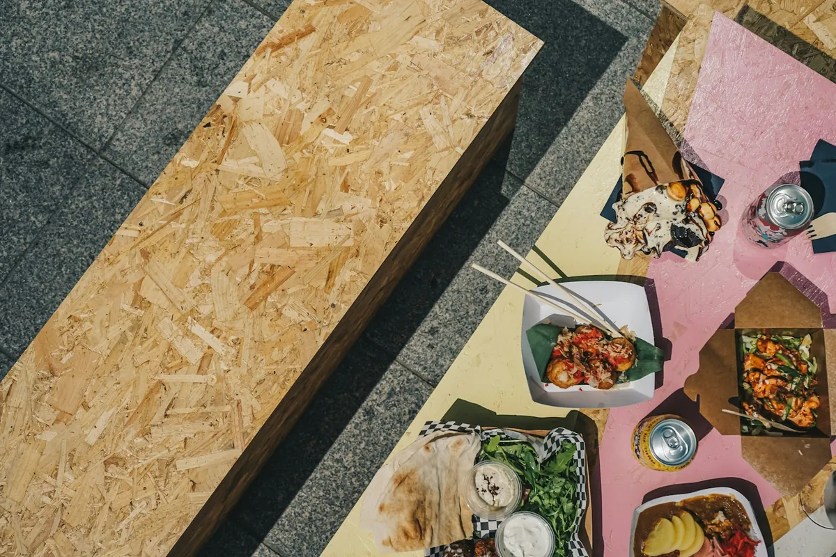 Large quart-size containers of Chinese food opened on a table