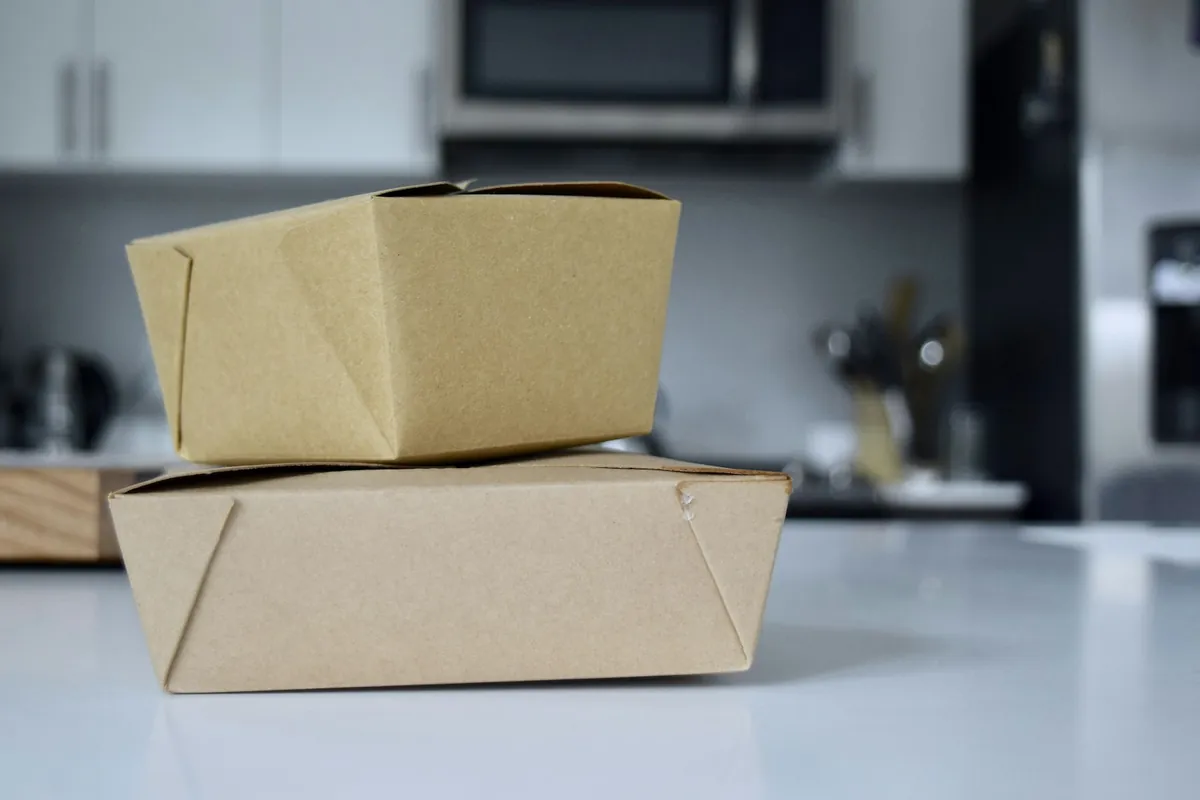 Rice and noodle dishes packed in takeout containers