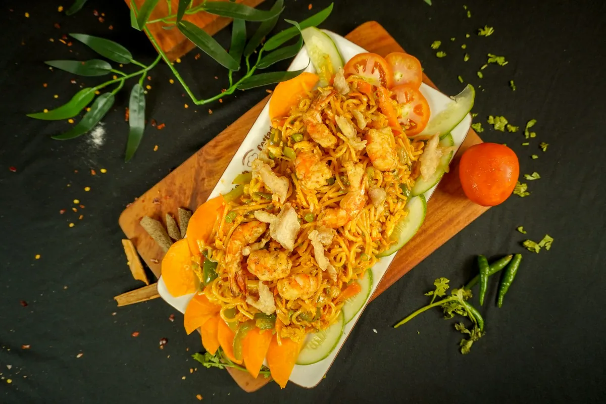 Rice noodles tossed with sliced vegetables and protein