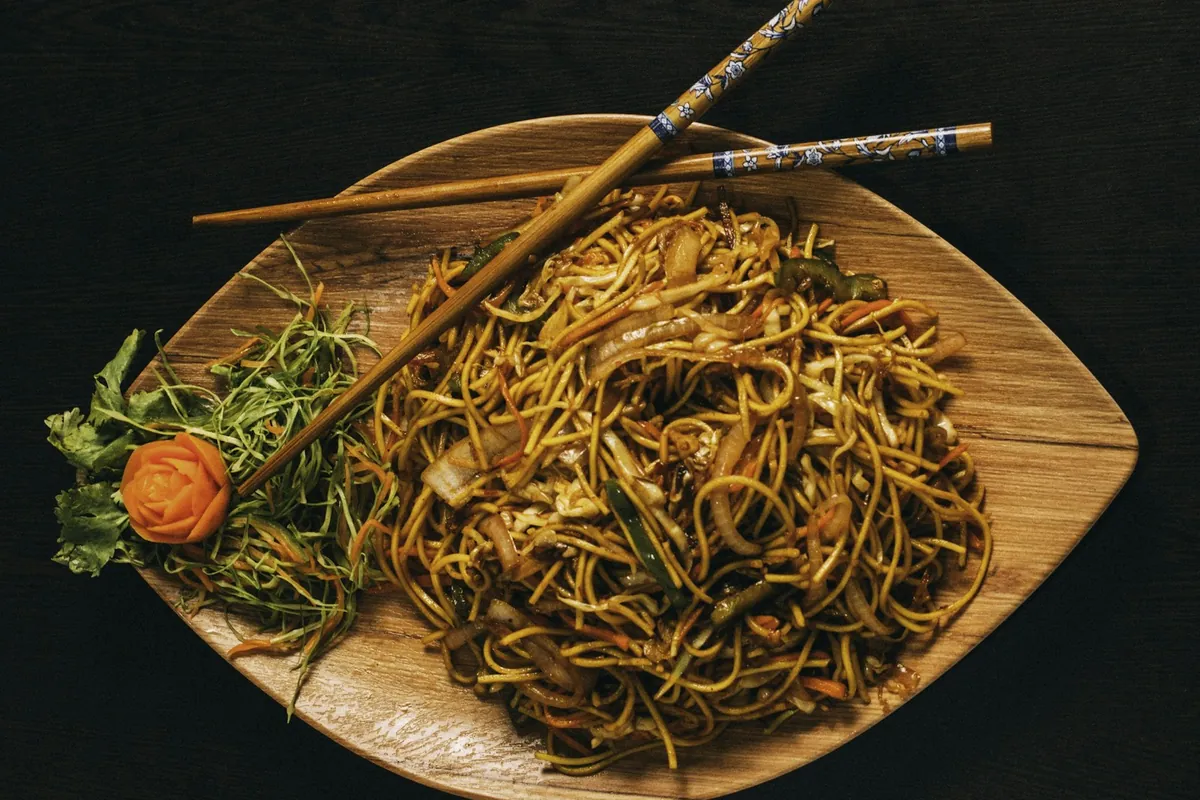 Close view of fine rice noodle strands separated with chopsticks