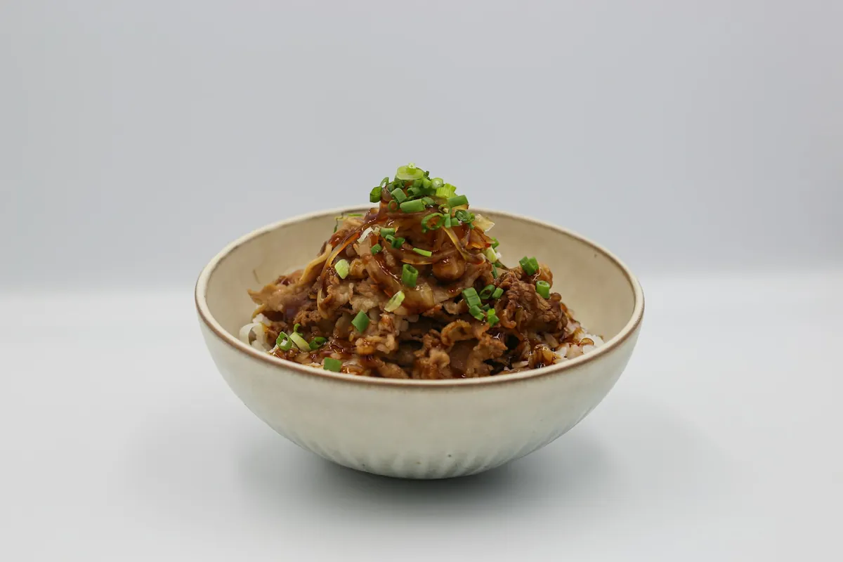 Roast meat served over rice in a box