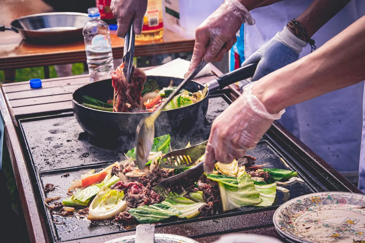 Sauce being added to food in a wok