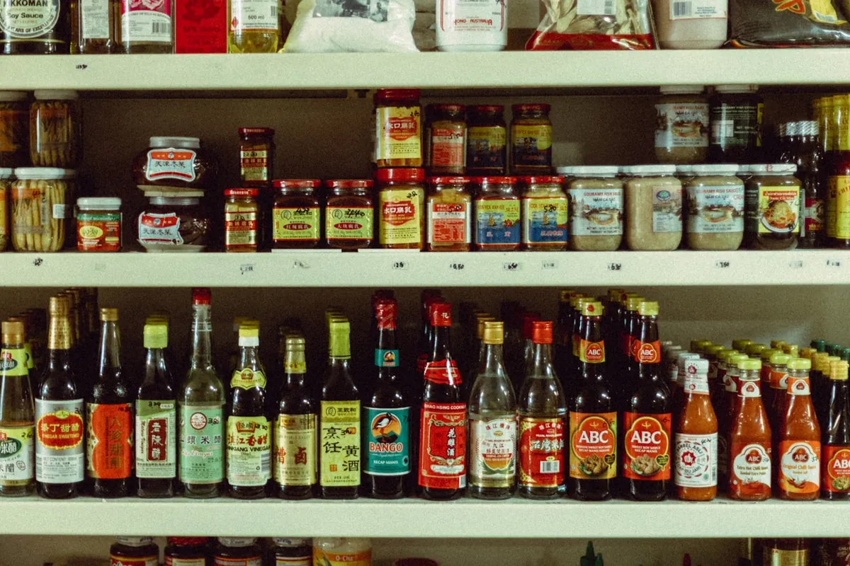A jar of sauce on a kitchen shelf