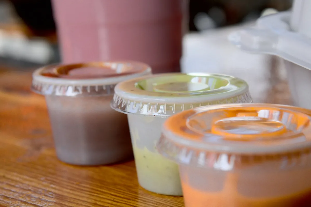 Sauce packed in a separate container beside a dish